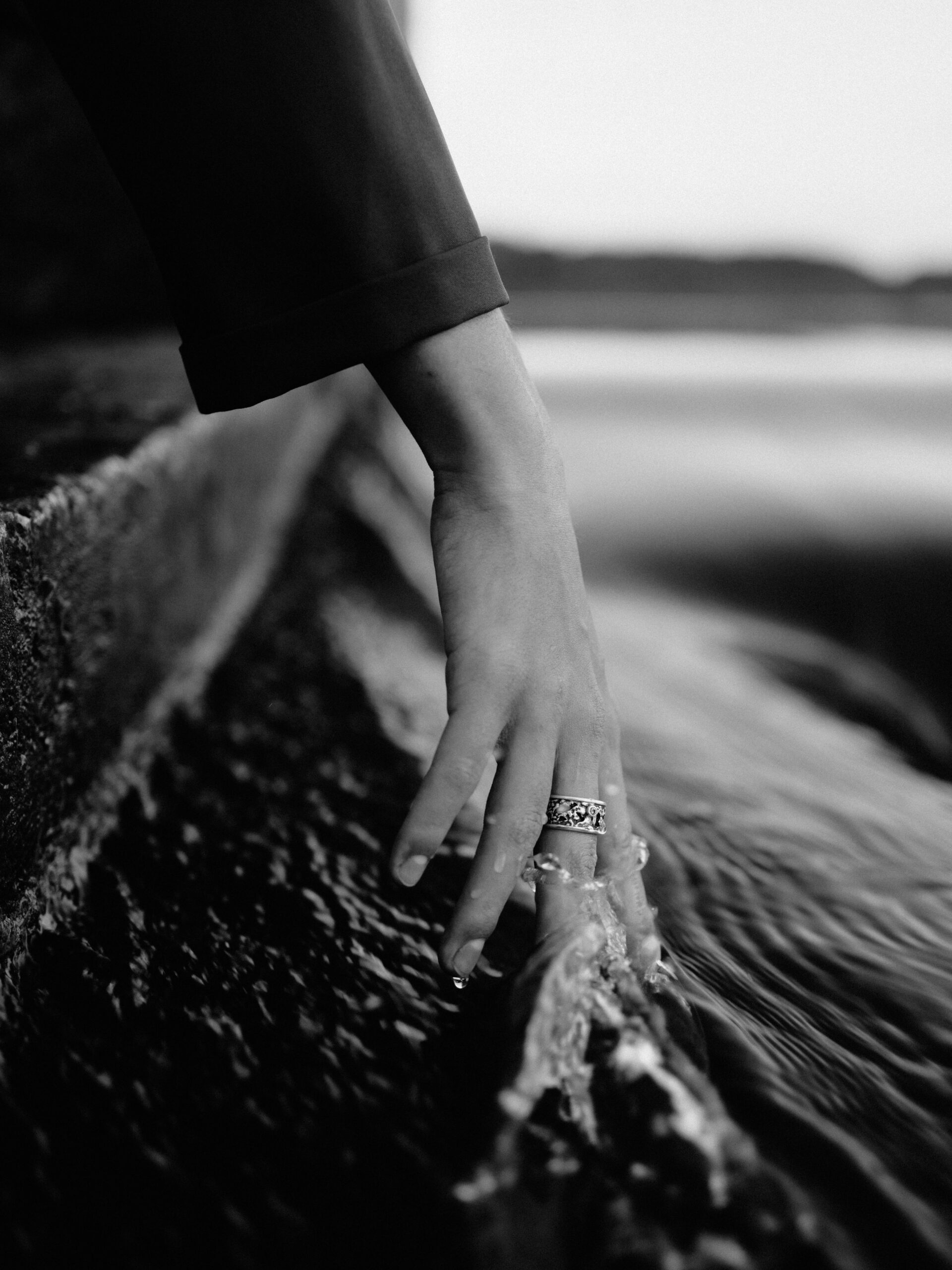 Woman's hand running in water alongside boat